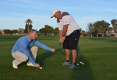 homepage image of instructor and golfer